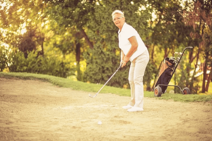 an senior woman playing golf