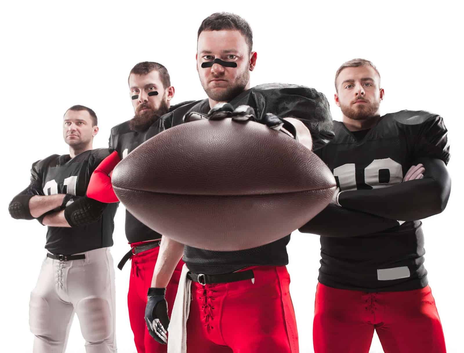 Four American football players with a ball