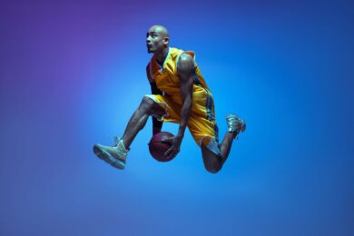 A man jumps up with a basketball