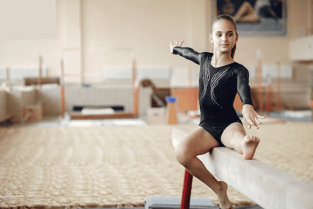 Girl gymnast during exercises on the balance beam