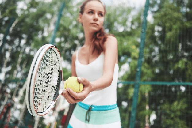 Girl with tennis racket and ball