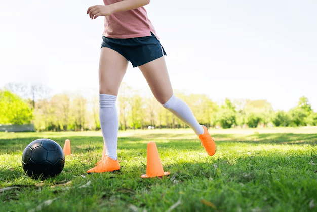 Young soccer player training on the field