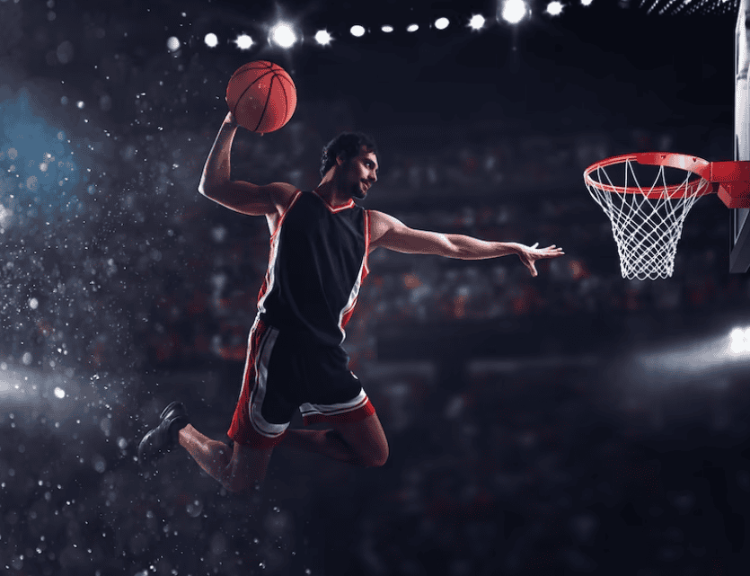 player throws the ball in the basket in a stadium full of spectators