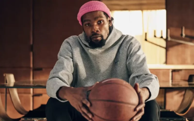 Kevin Durant Sits and Holds a Ball