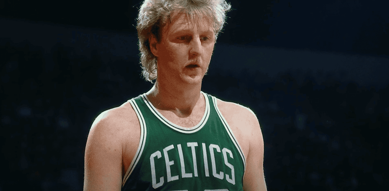 Larry Bird wearing a green Celtics jersey