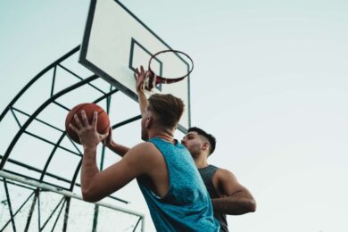 Two men are playing basketball