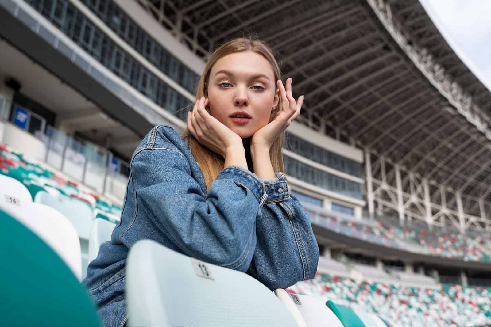 A woman sits in the tribunes