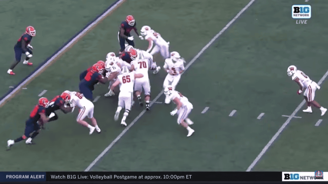 two teams of football on the field, ones in blue color form, another in white