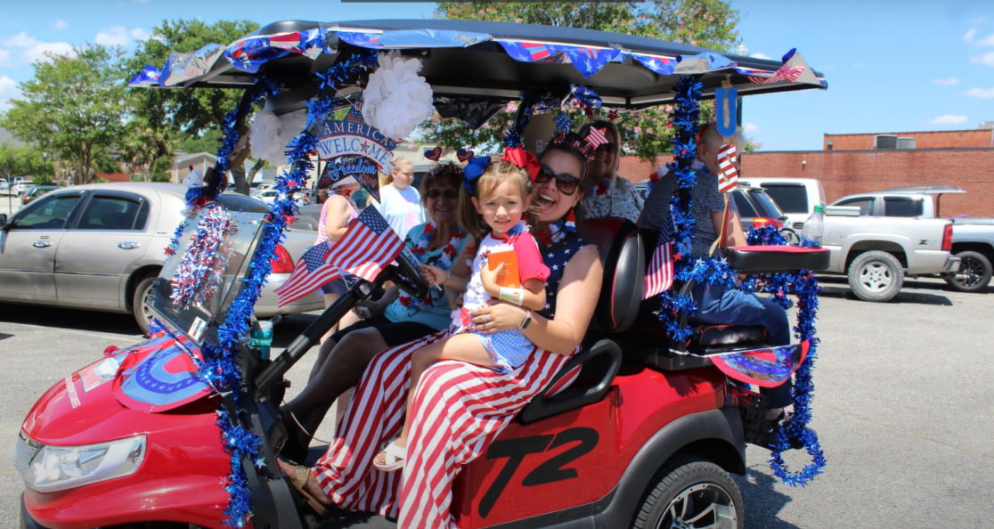 Family in a decorated golf cart